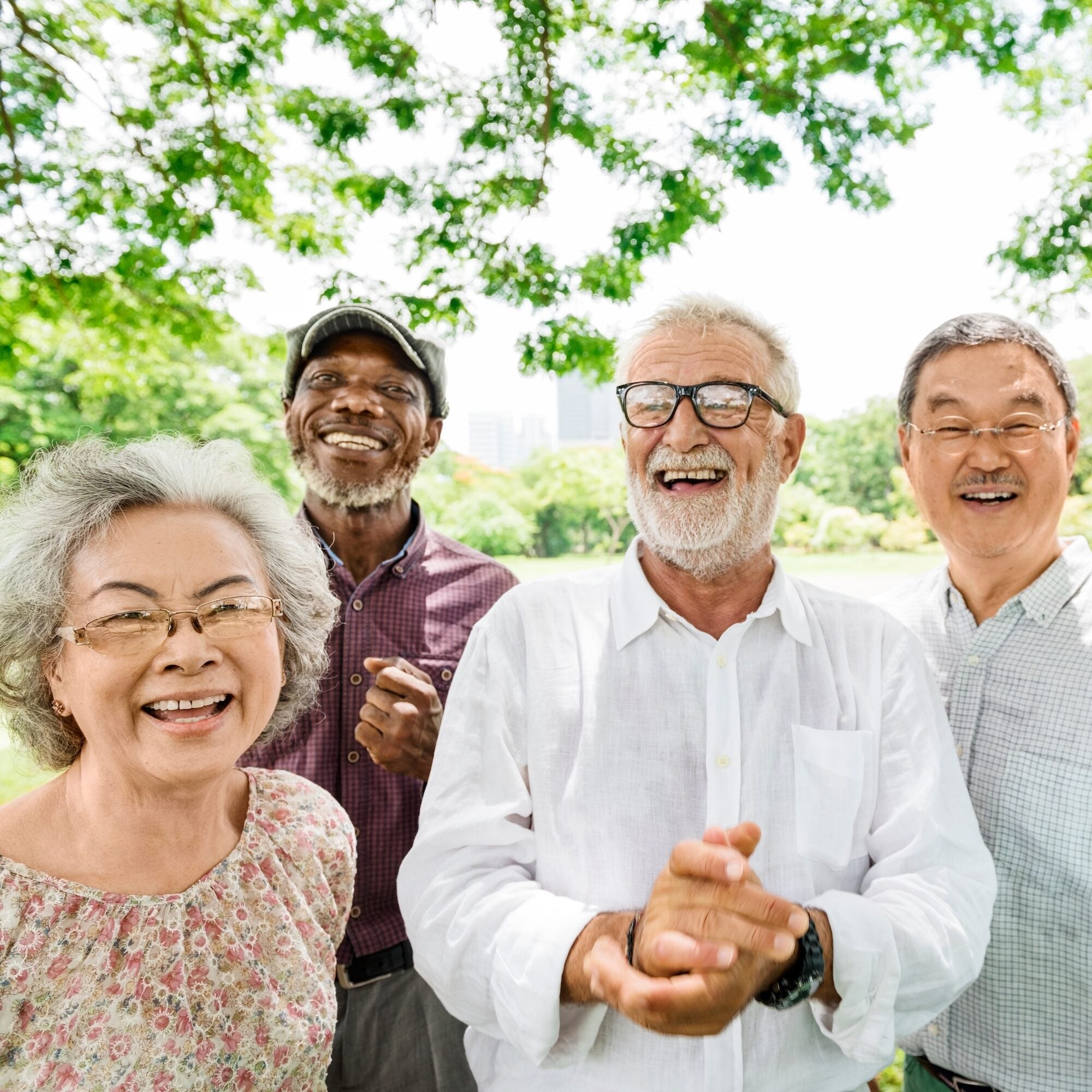 A group of older individuals standing in a group and smiling
